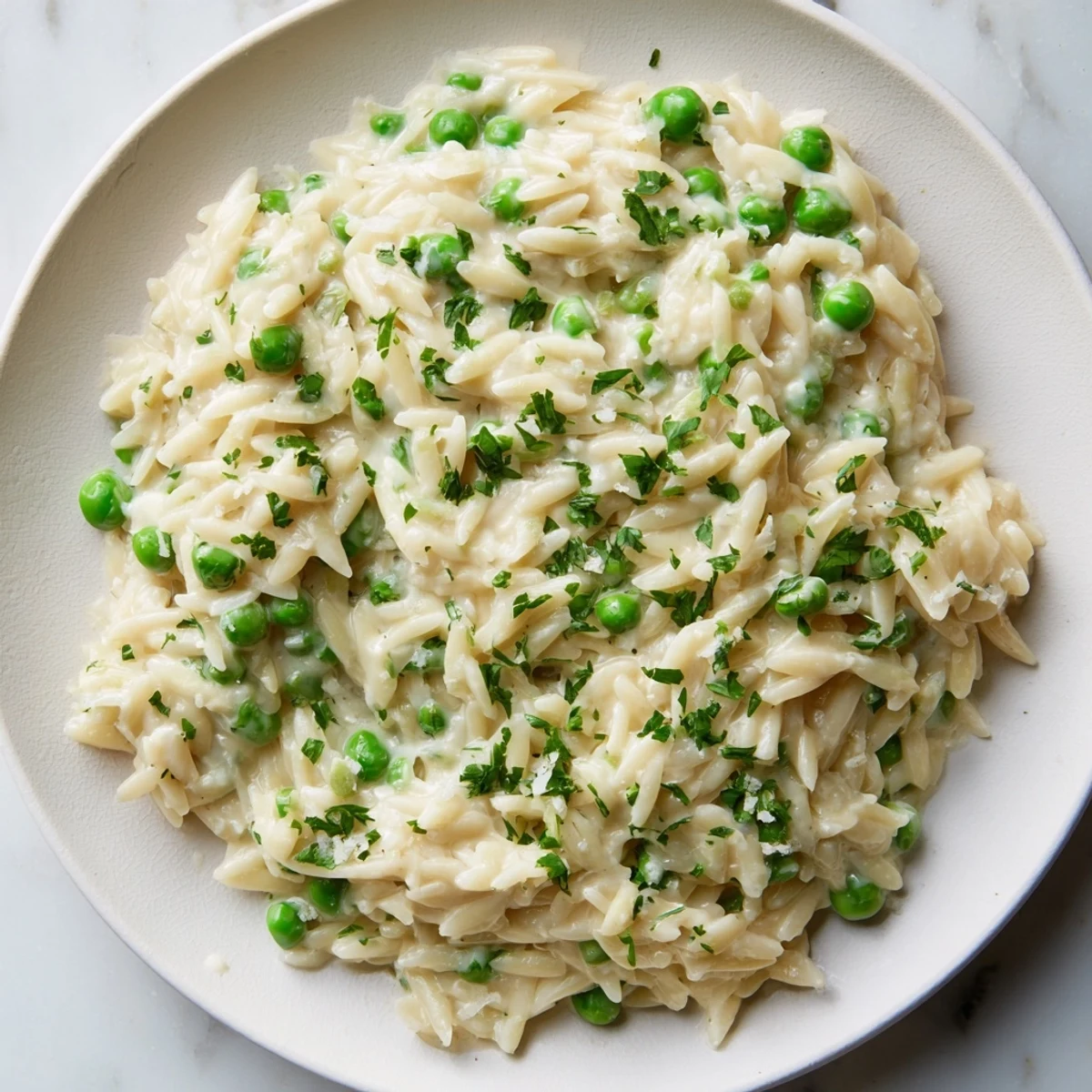 Creamy Parmesan Orzo with Green Peas: a comforting plate of creamy pasta with vibrant, sweet peas.