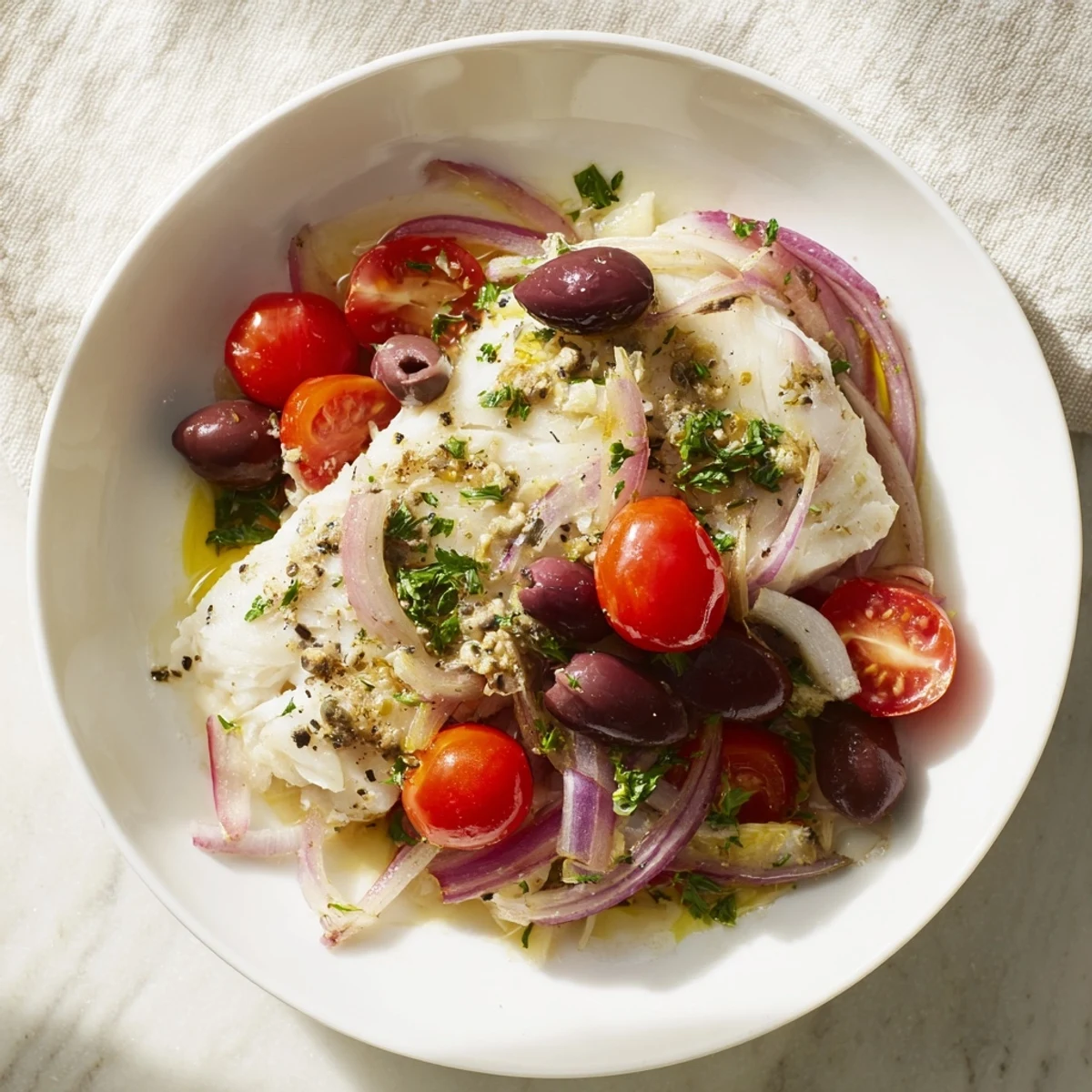 One-Tray Baked Cod with juicy cherry tomatoes, olives and herbs ready to eat.