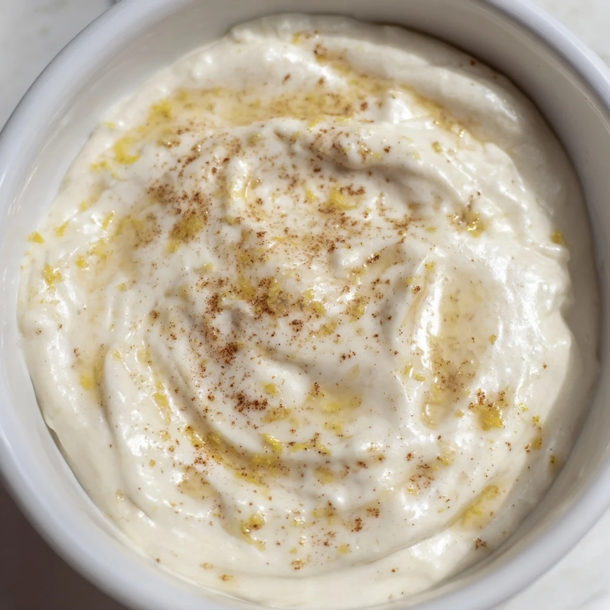 A vibrant photo of Greek yogurt fruit dip, swirled with honey and served alongside colorful berries.