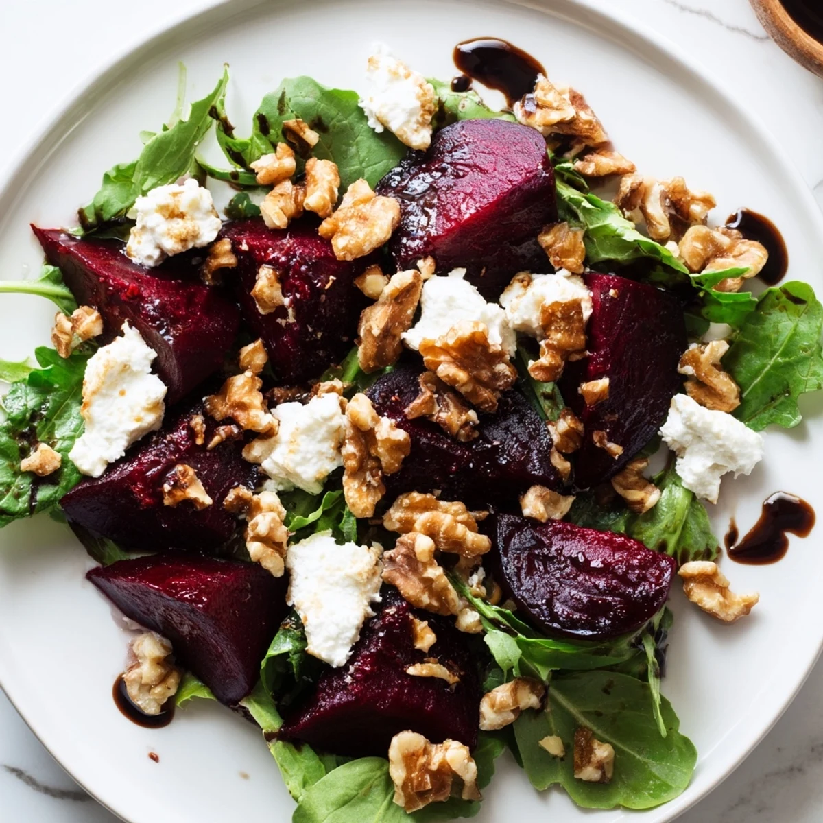 Beet and Goat Cheese Salad, vibrant red beets alongside creamy goat cheese and walnuts, ready to eat.
