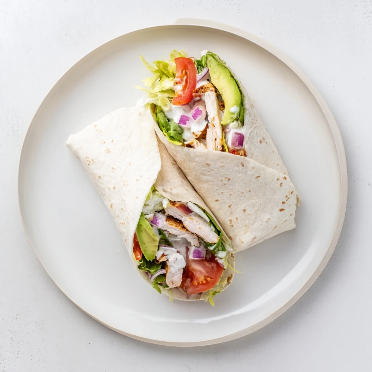 Smoky Chipotle Chicken Wrap served warm with a side of tangy Greek yogurt sauce and lime wedges on a rustic wooden table.