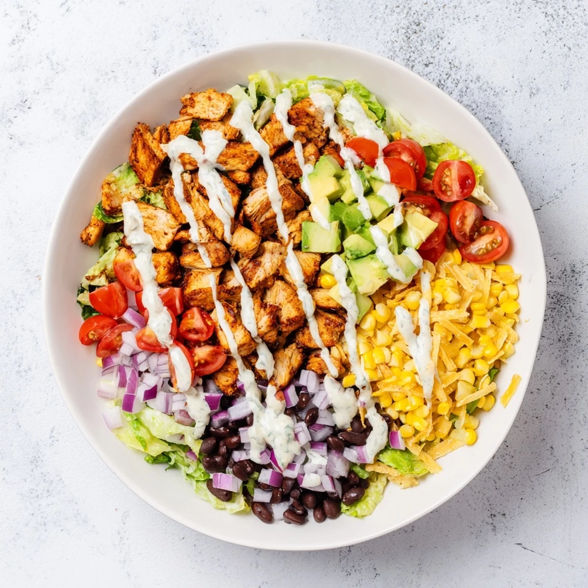 This easy Tex-Mex Chicken Taco Chopped Salad features juicy chicken, crunchy tortilla chips, and fresh avocado for a satisfying meal.