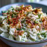 Tender cabbage ribbons in a rich coconut curry sauce, topped with toasted coconut flakes, served alongside rice or grilled chicken.  
