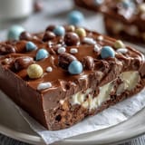 1. Pastel Chocolate Bark with Cadbury Eggs: vibrant swirls of pink, yellow, and blue candy melts over smooth white chocolate, topped with crunchy mini Cadbury eggs and sprinkles.  