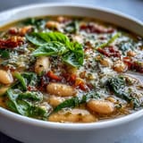 Creamy Tuscan white bean and spinach soup with tender vegetables and aromatic herbs, slow-cooked to perfection.