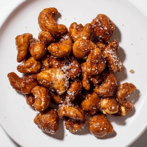 Close-up of freshly baked Sweet and Salty Honey Toasted Cashews offering a delightful sweet and savory snack.