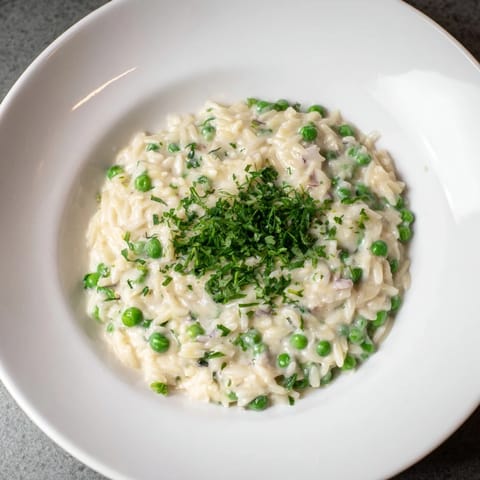 One-pan Creamy Parmesan Orzo with Green Peas, a vegetarian delight ready in under 30 minutes.