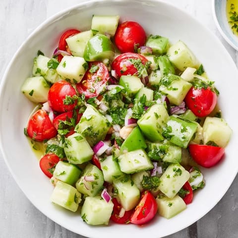 This Fresh Cucumber and Chickpea Salad shows a close-up of fresh ingredients, tossed and ready to eat.