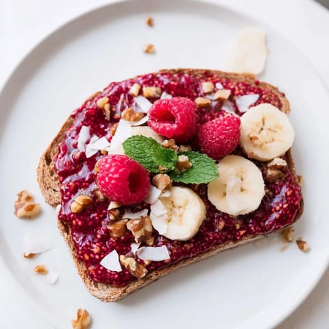 Freshly made raspberry chia jam glistens on toasted bread, a sweet and delicious treat to enjoy.
