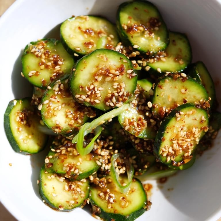 Shake Shake Garlic Cucumbers are ready to enjoy, piled in a rustic bowl with minced garlic and chili flakes visible, suggesting a crunchy, bold-flavored snack.